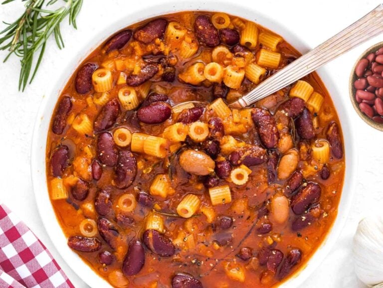 Pasta e fagioli with a silver spoon