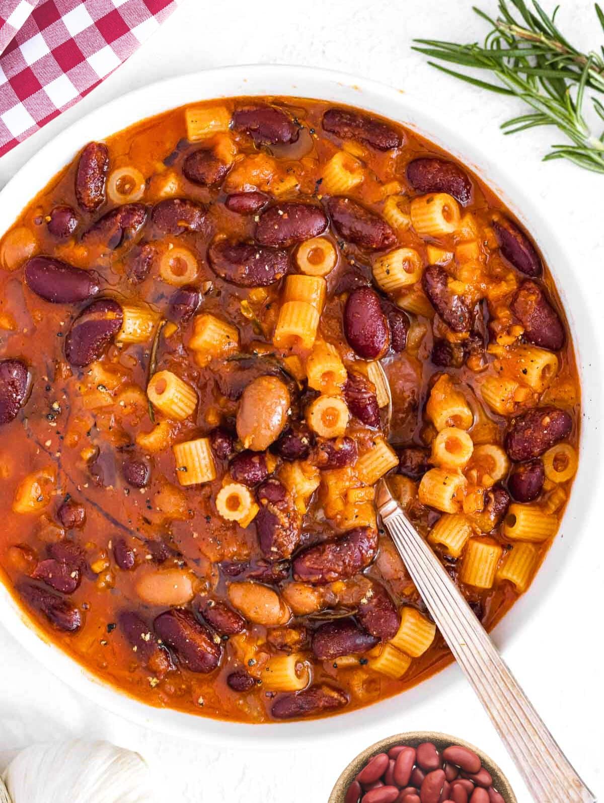 Pasta e fagioli with a silver spoon