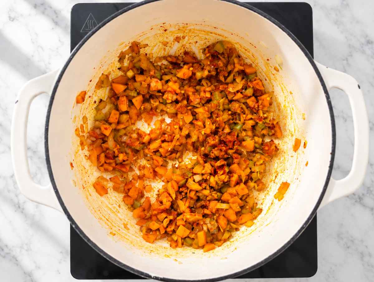 Step 1 Onion, carrots, and celery cooking with garlic, tomato paste, and spices.