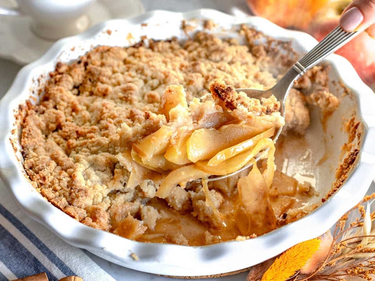 Apple crumble with a silver spoon