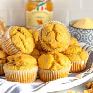 Cornbread muffins served with honey on a blue cloth