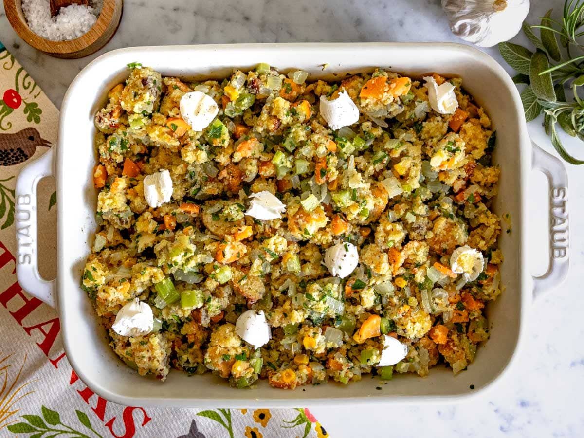 scoops of butter on cornbread stuffing before baking