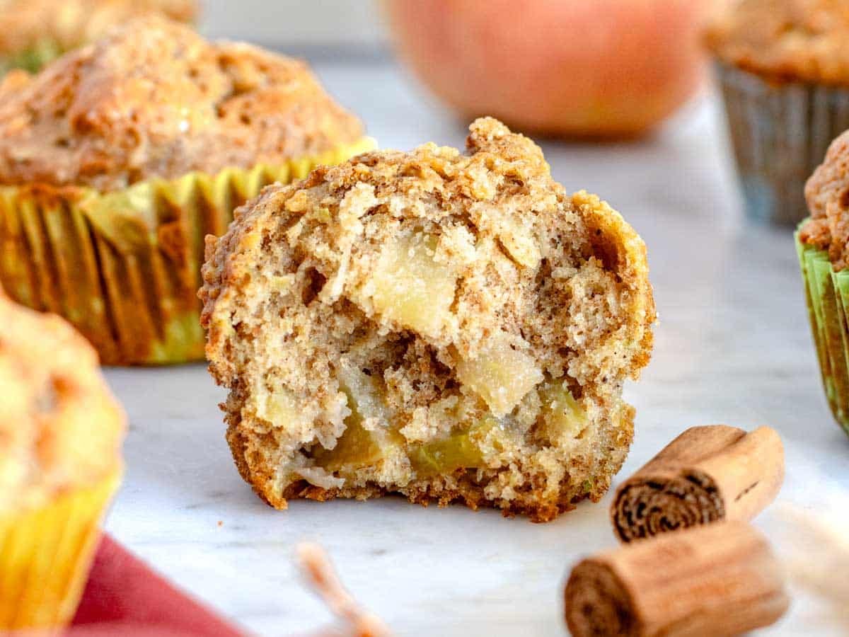 Apple muffin cut in half where you can see the apple filling.