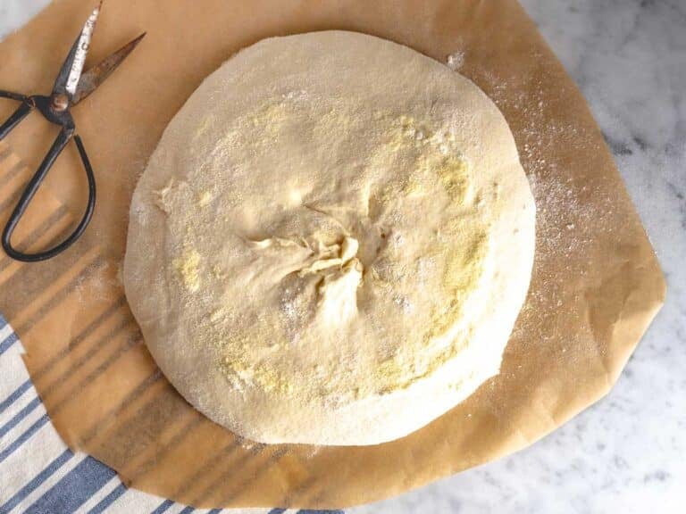 Bread dough on a sheet of parchment paper.