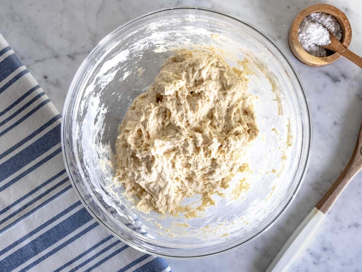 Mixing flour and salt with the water-yeast mixture.