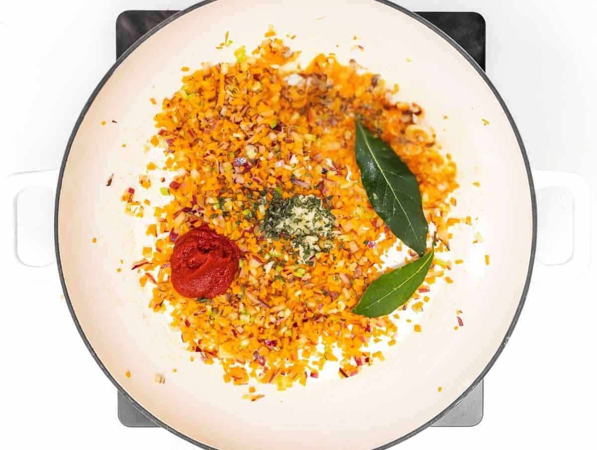 Step 1 Chopped onion carrot celery sauteฬing in pot to start Italian bean soup base.