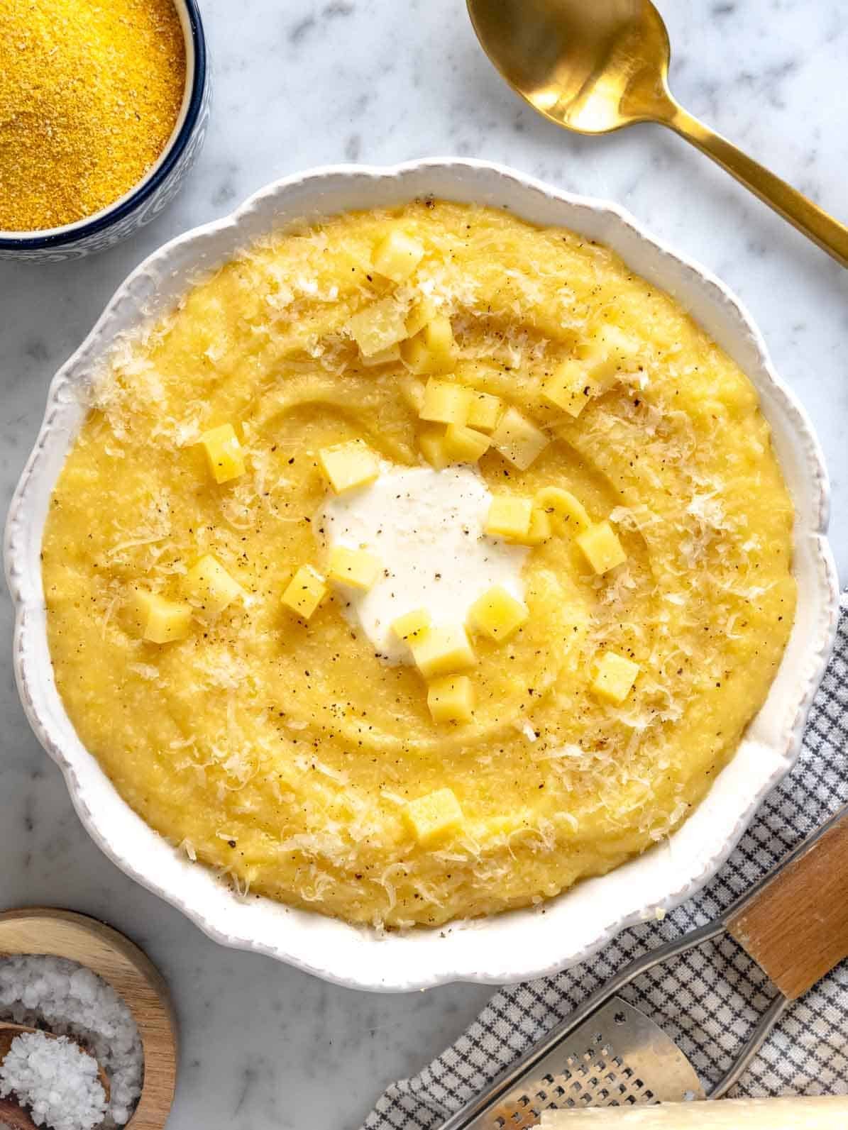 Creamy polenta with parmesan cheese in a white bowl