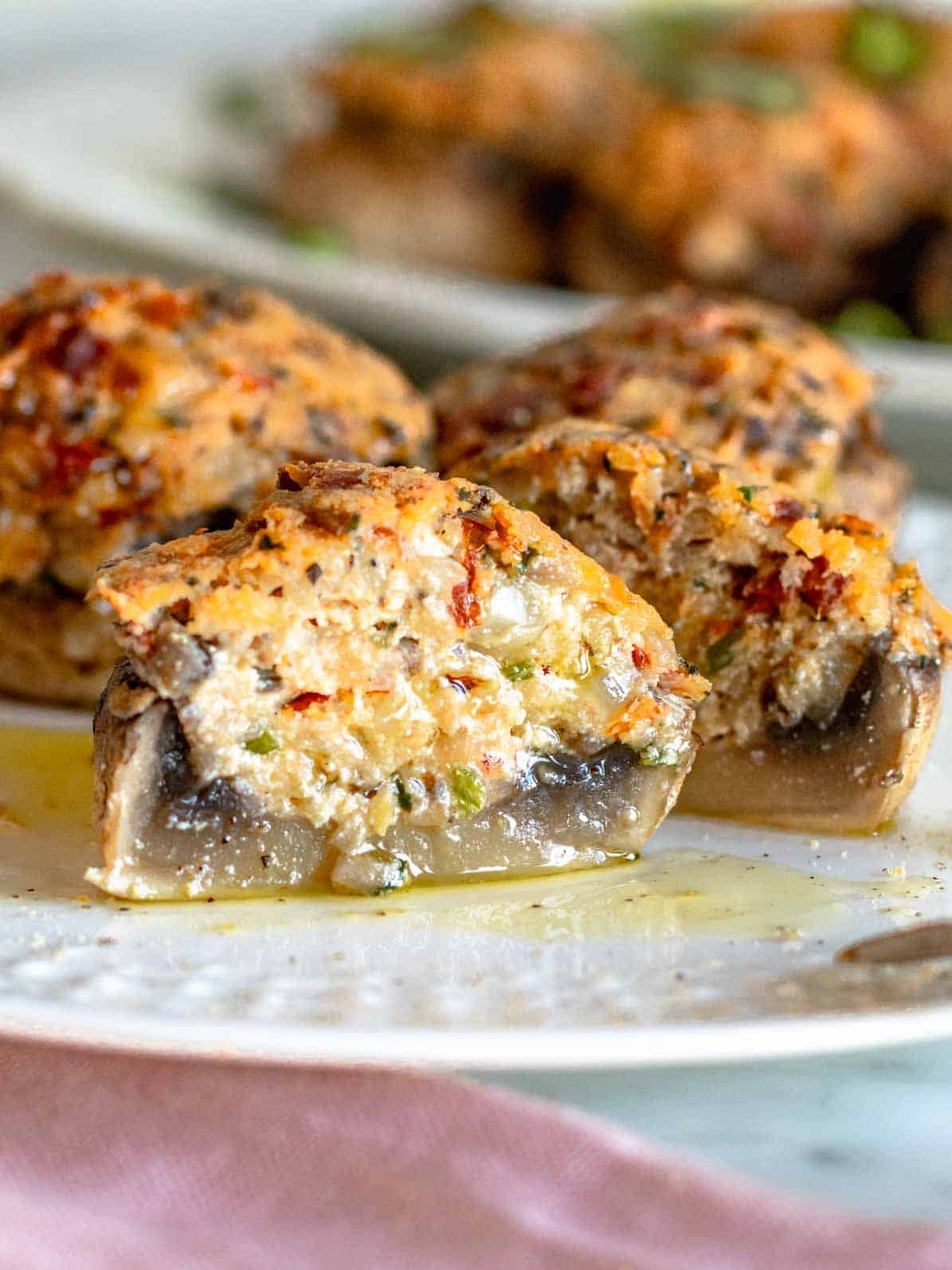 stuffed mushrooms with ricotta cut into half on a plate