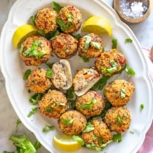 stuffed mushrooms with ricotta on a white serving plate