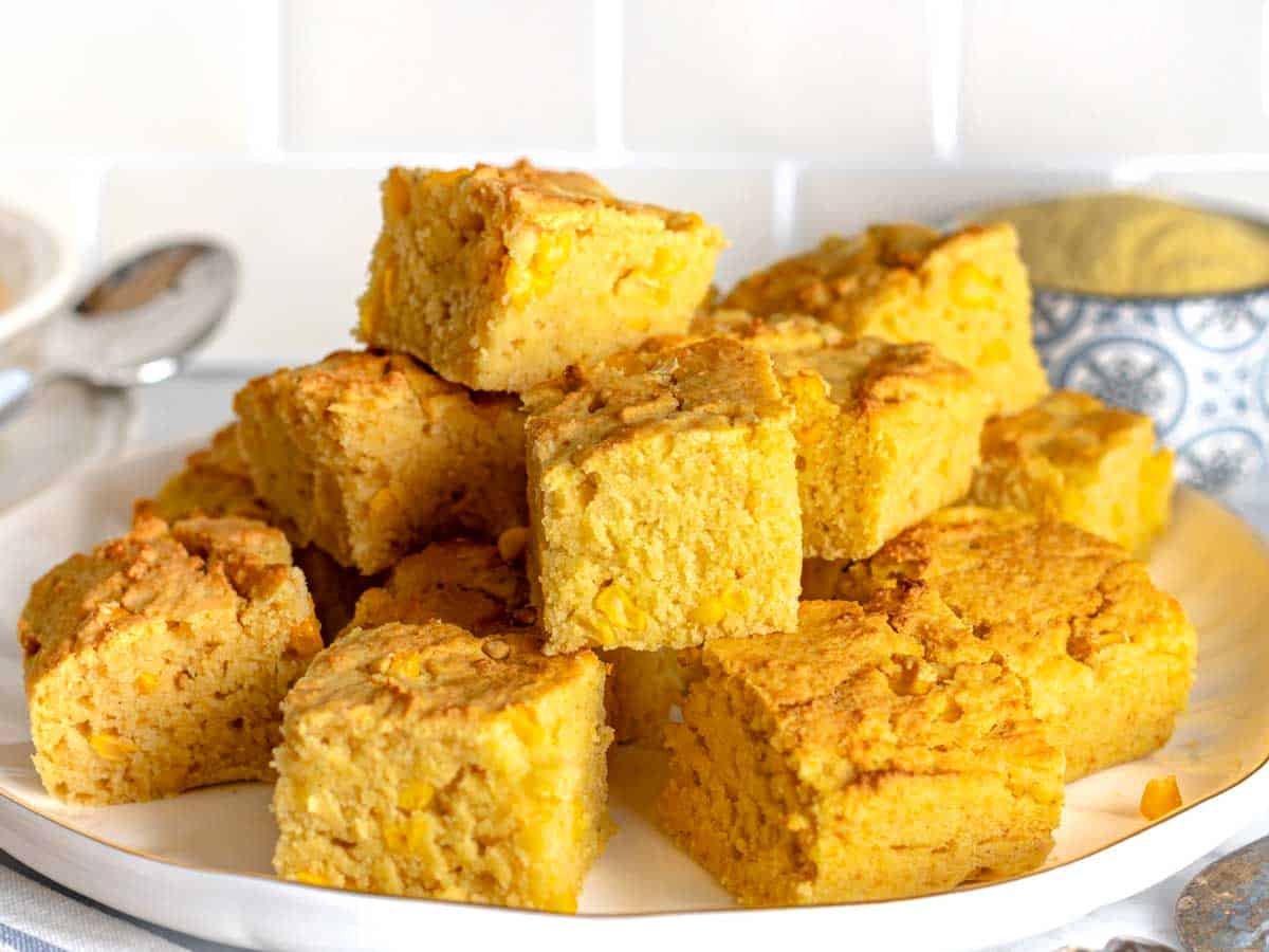 vegan cornbread on a white plate with corn kernels