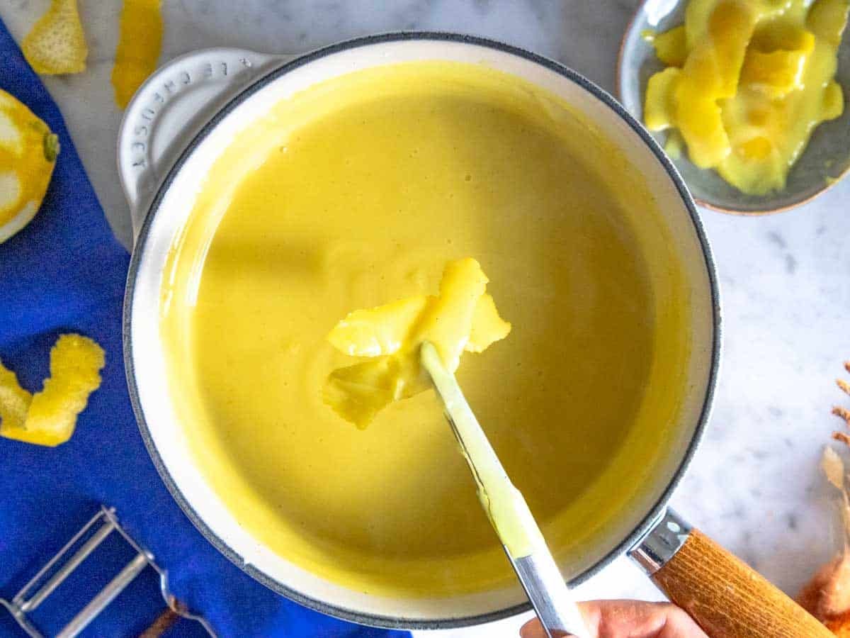 Removing the lemon peel from the vegan custard.