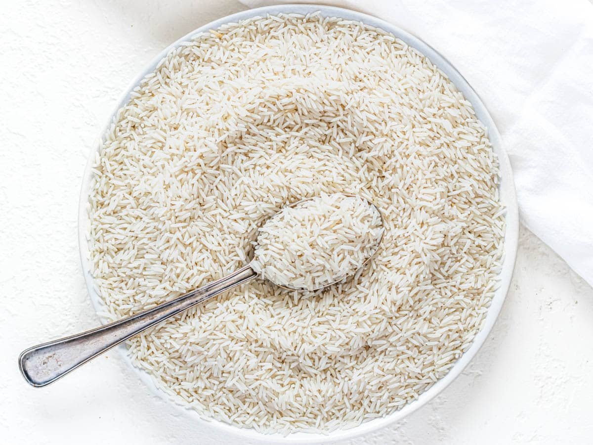 Basmati rice on a white plate before cooking.