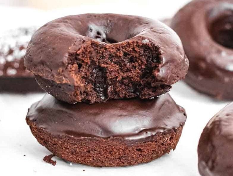 Chocolate donuts with a bite.