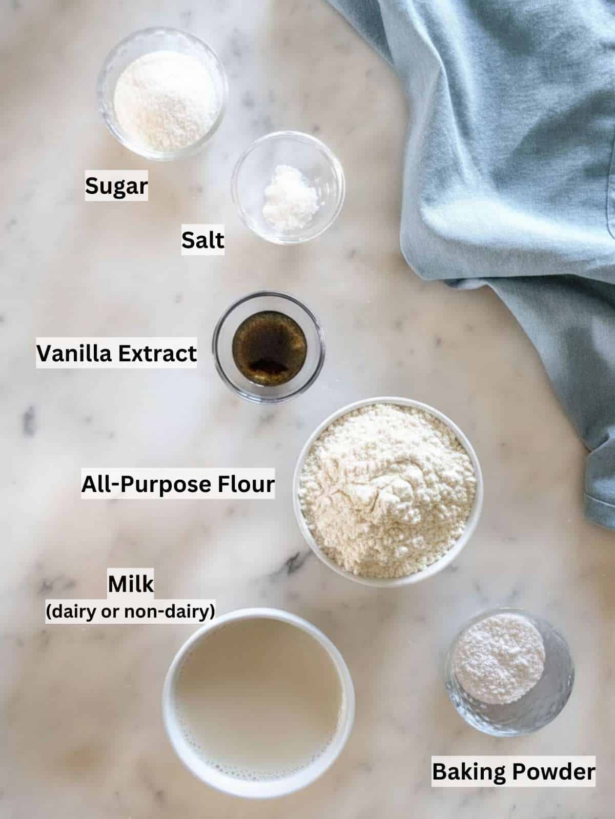 Simple pantry ingredients for egg-free pancakes flour milk sugar baking powder vanilla.