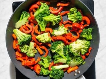 Step 2 Broccoli and red bell pepper cooking until bright and tender-crisp.