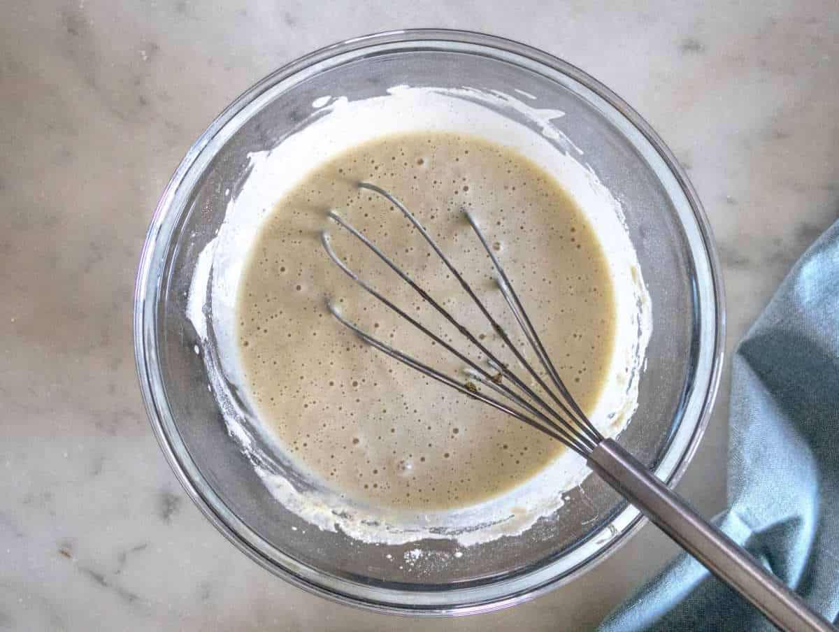 Step 2 Whisking milk and vanilla into batter then resting for fluffy pancakes.