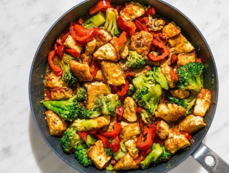 Step 3 Tofu and vegetables tossed in thick, glossy orange sauce.