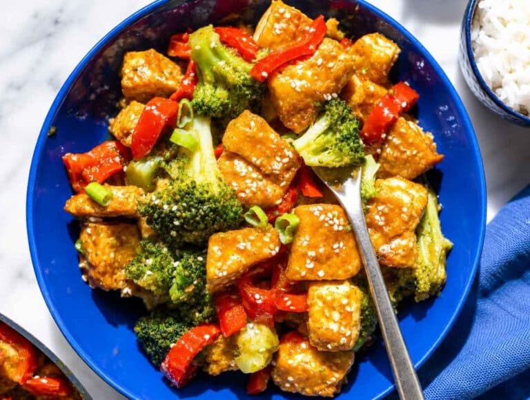 Step 4 Orange tofu served over rice with green onions and sesame seeds.