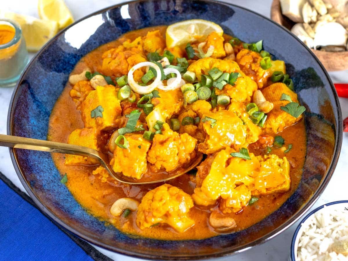 Tofu and cauliflower curry in a bowl.