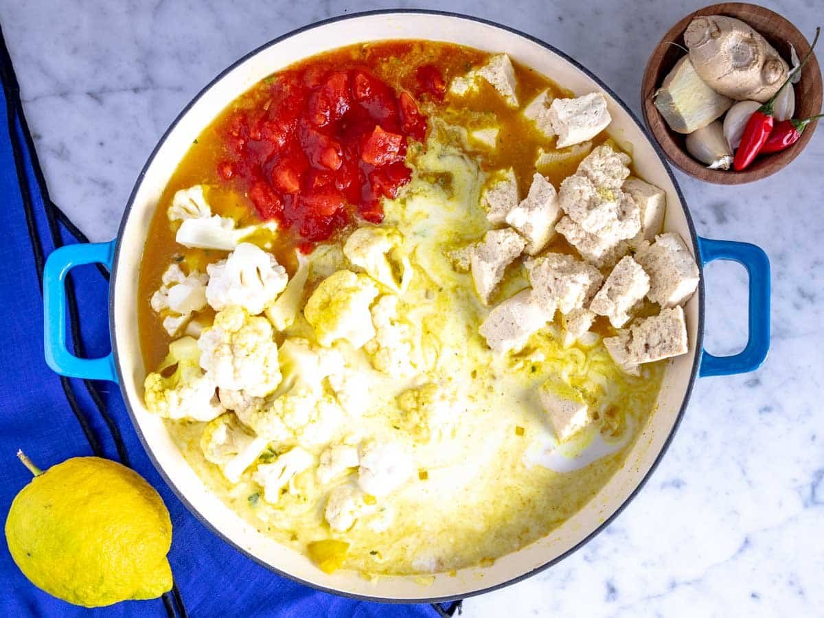 All ingredients for tofu curry in one large skillet.