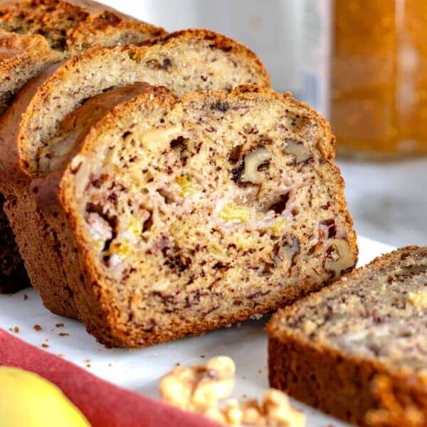 Banana nut bread sliced on a cutting board.