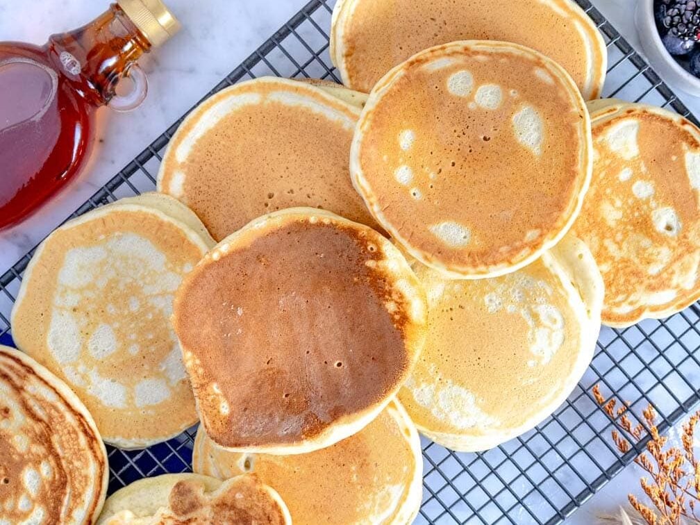 vegan pancakes cooling down on a grid.