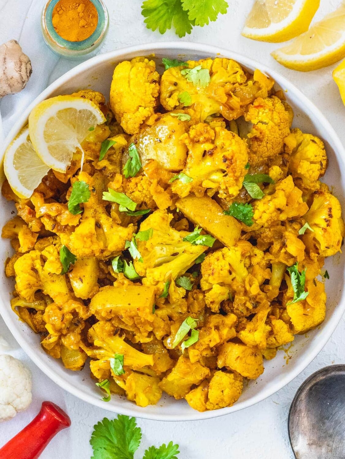 Aloo Gobi in a bowl with lemon slices