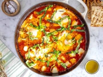 Eggs in purgatory with toasted bread and salt on the side.