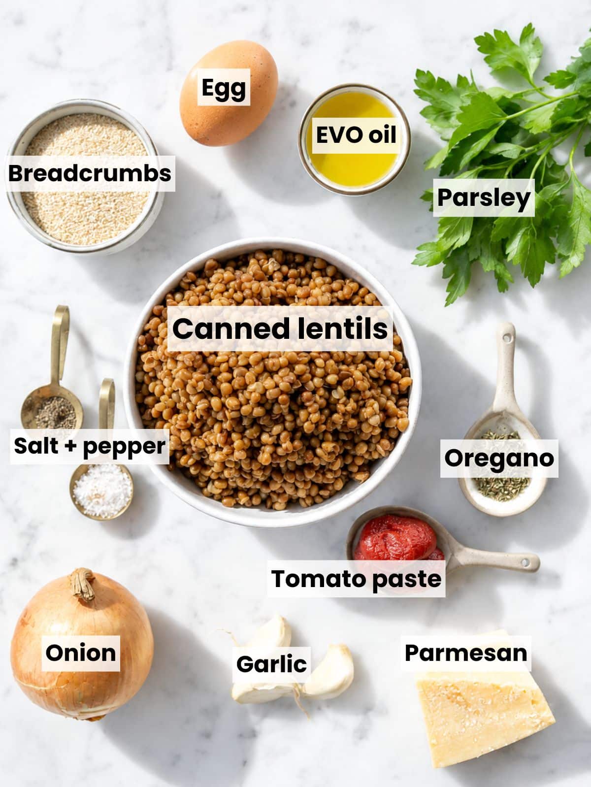 Lentil meatball ingredients arranged on Carrara marble in natural window light.
