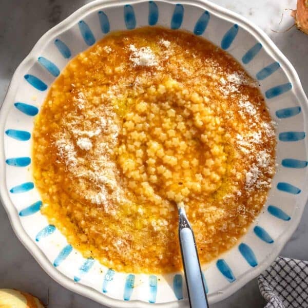 Pastina soup with parmesan in a bowl.