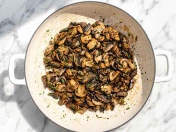 Step 1 Sliced mushrooms browning in olive oil with garlic and fresh parsley.