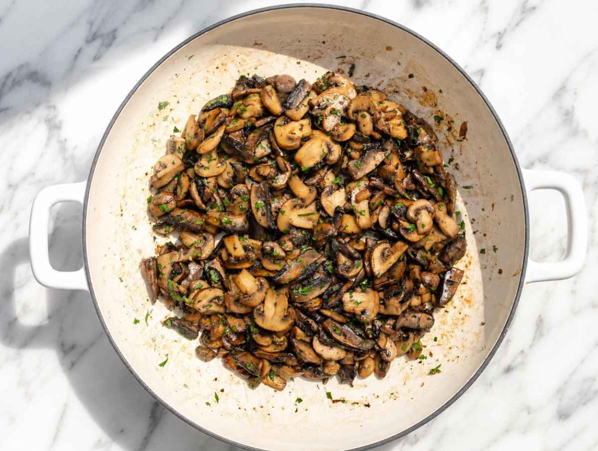 Step 1 Sliced mushrooms browning in olive oil with garlic and fresh parsley.