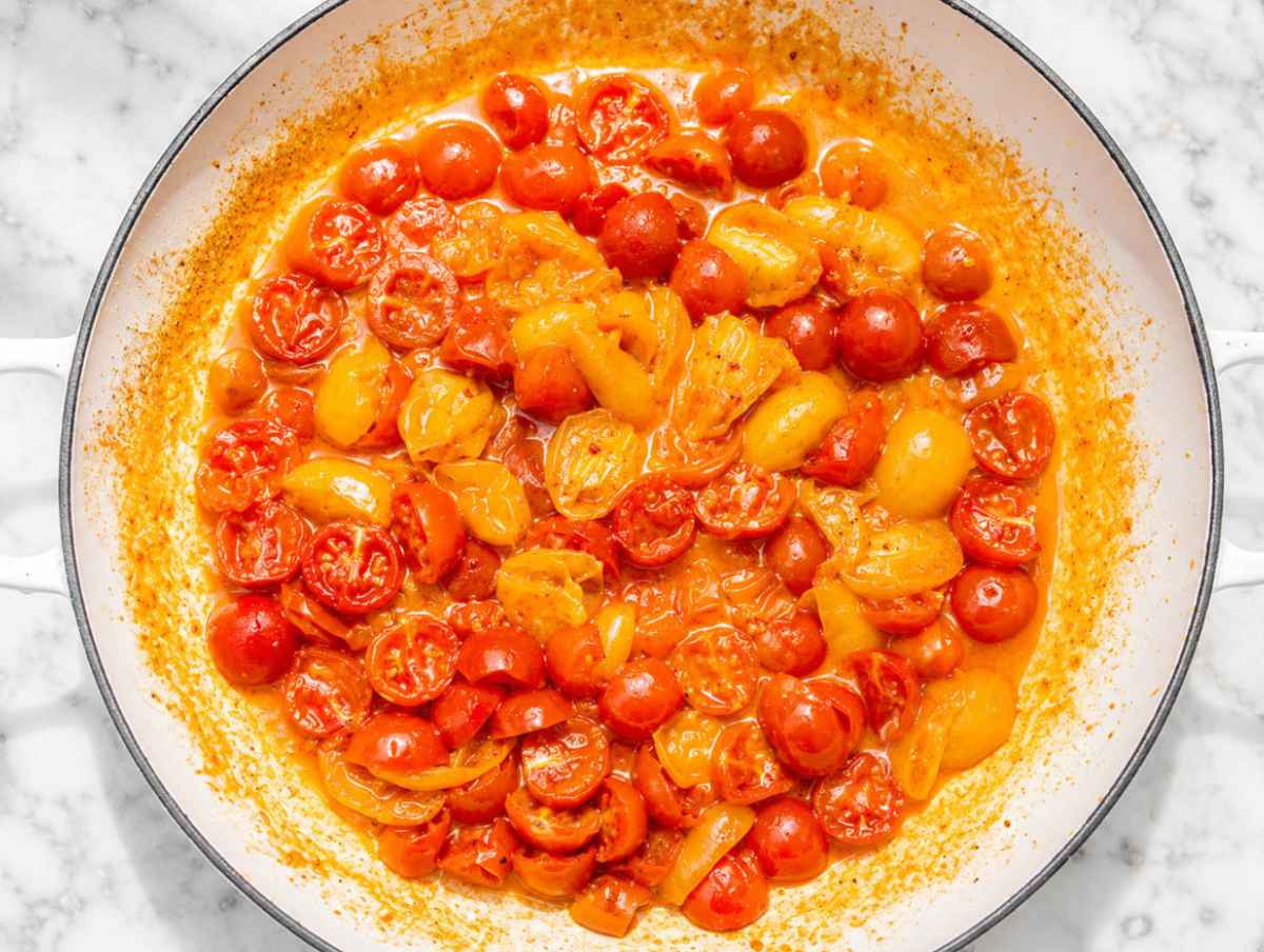 Step 2 Cherry tomatoes cooking with garlic, olive oil, and red pepper flakes.