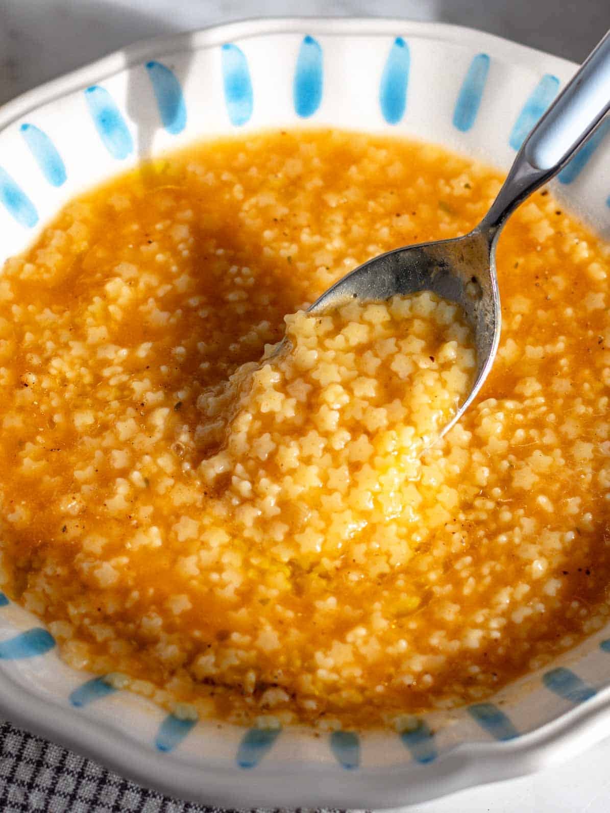 Italian pastina soup with a spoon.