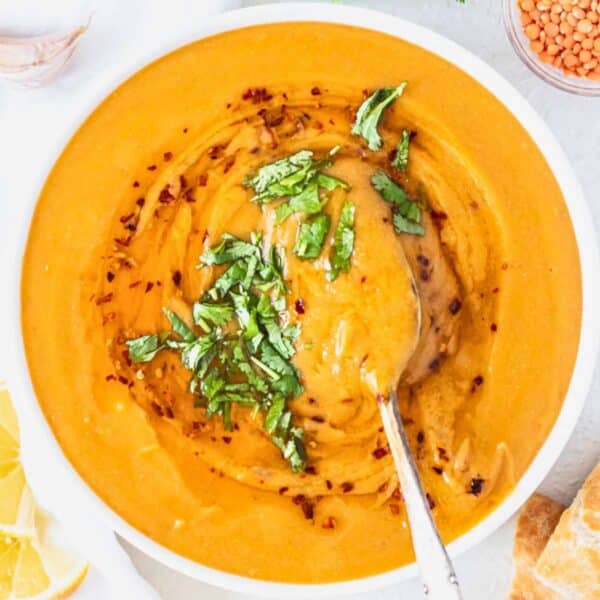 turkish red lentil soup in a white bowl.