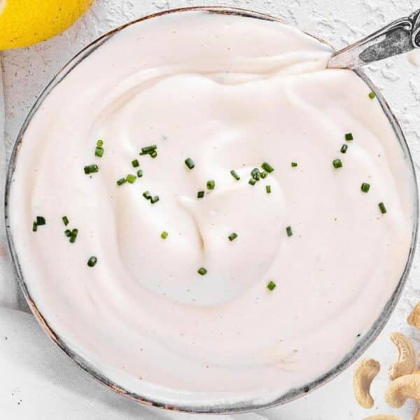 vegan easy sour cream in a bowl with a spoon.