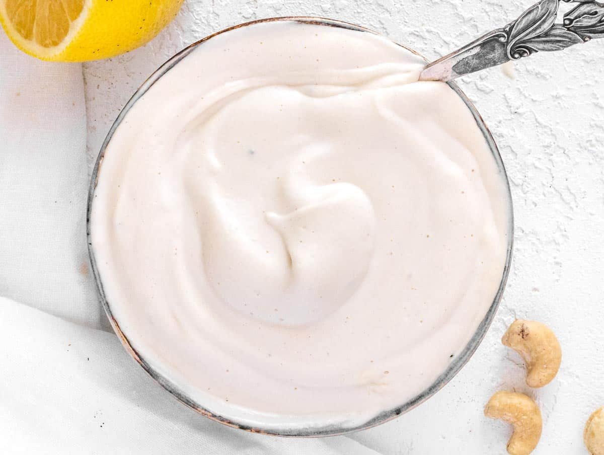 vegan sour cream with a silver spoon.
