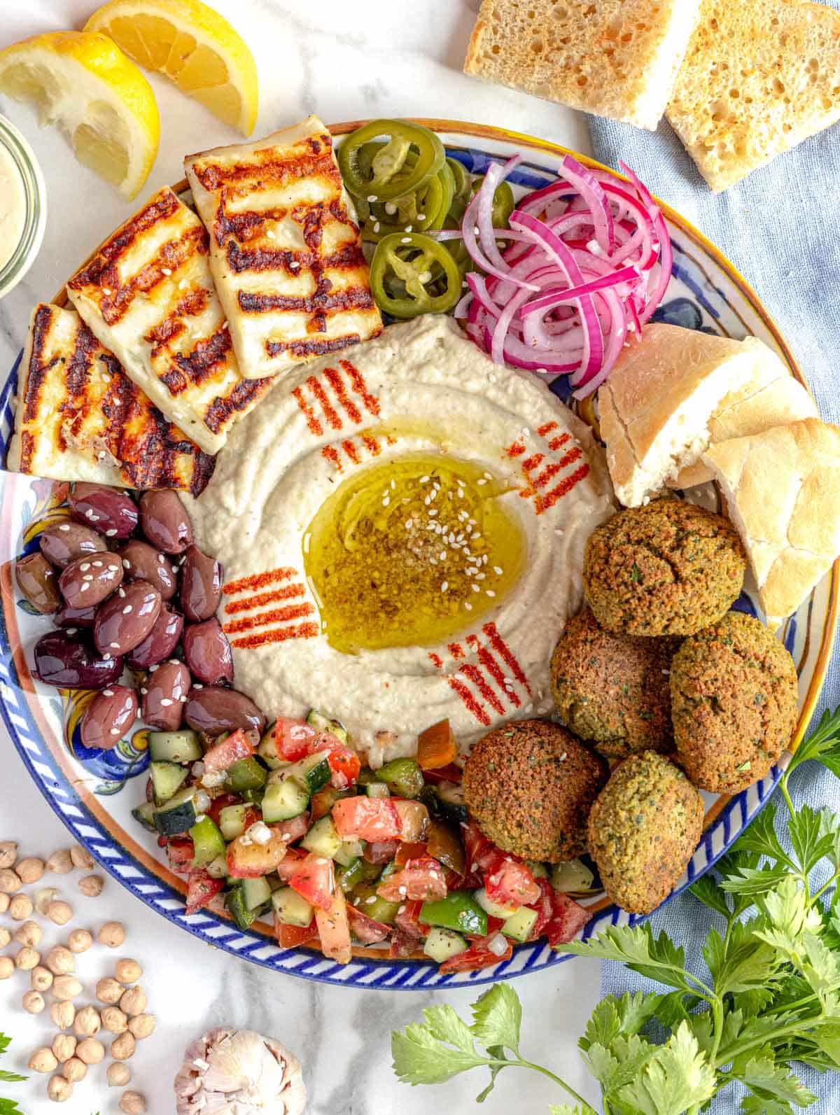 vegetable side dishes with olives, shirazi and pickled vegetables.