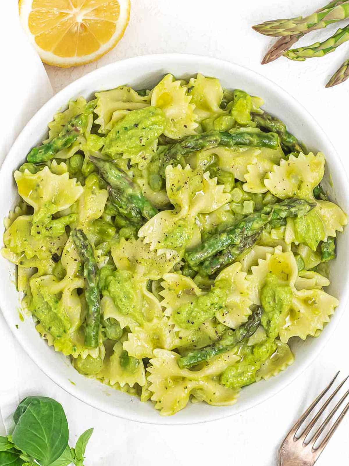 Asparagus pasta served in a white bowl.