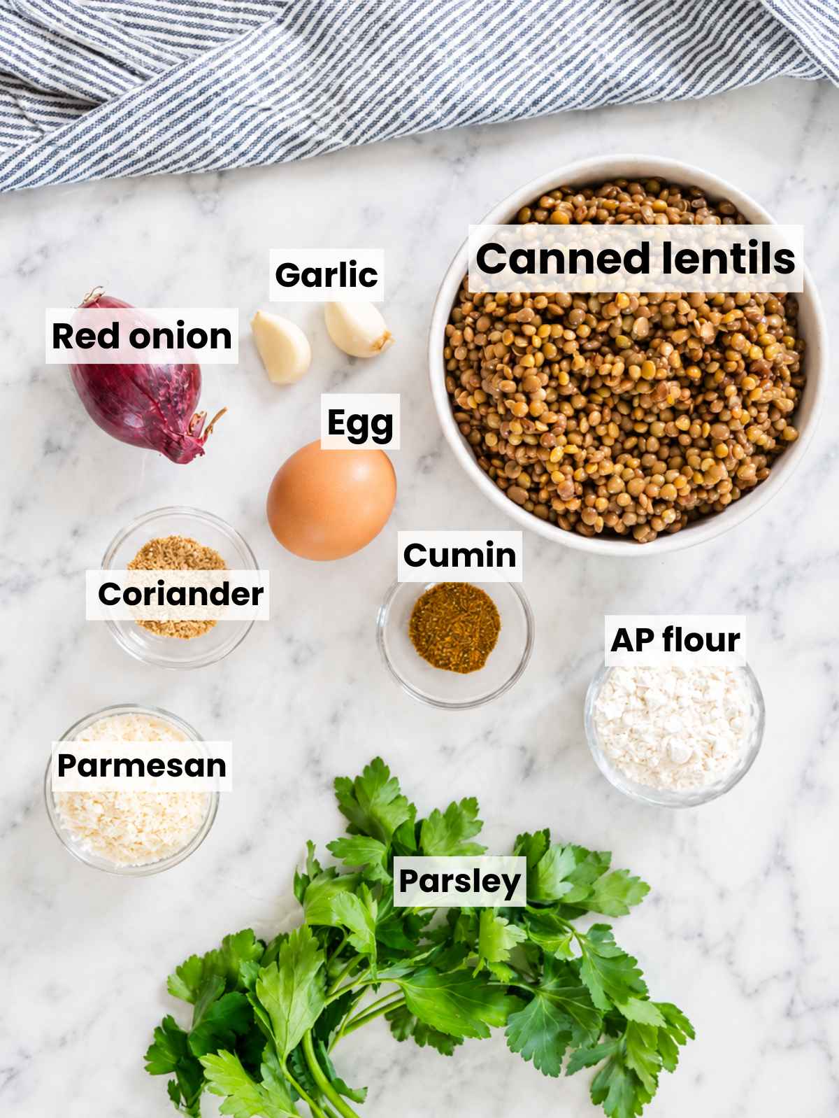Canned lentils, egg, parmesan, flour, parsley, onion, garlic, spices, and lemon.