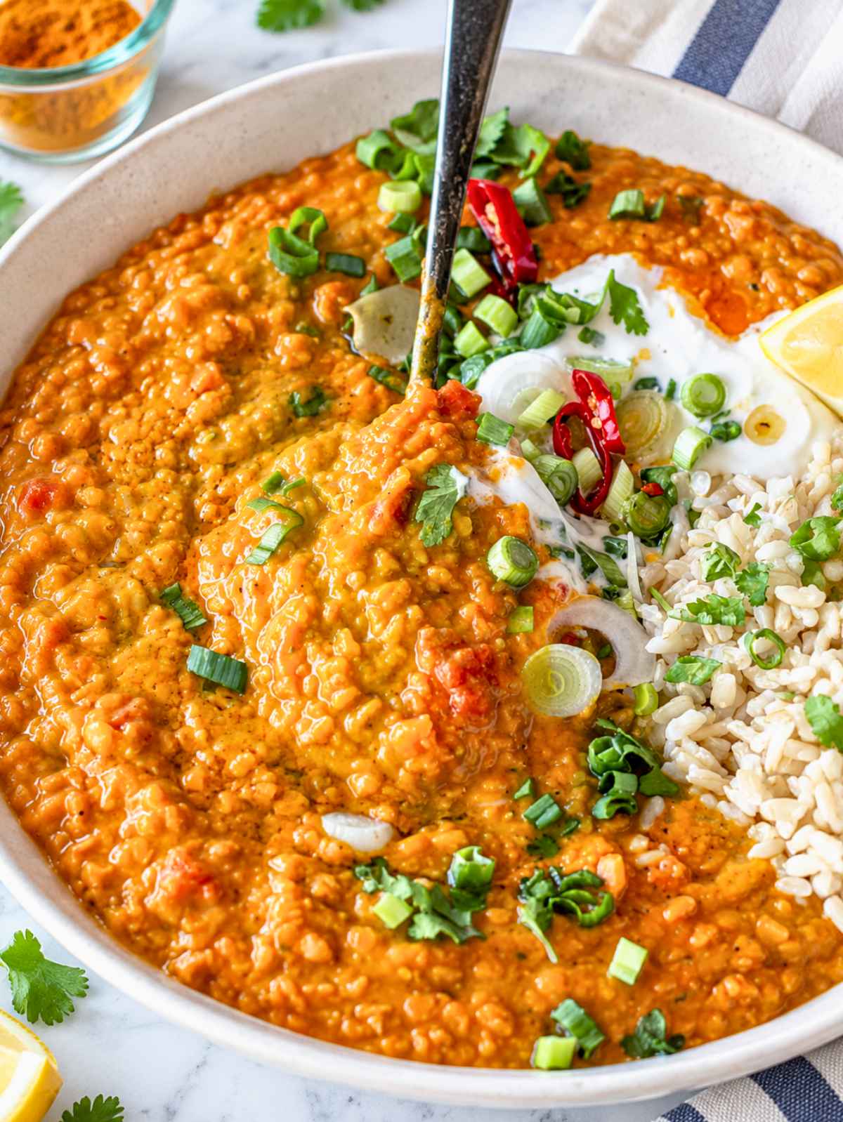 Close-up of creamy lentil curry showing tender split red lentils and richly spiced tomato sauce