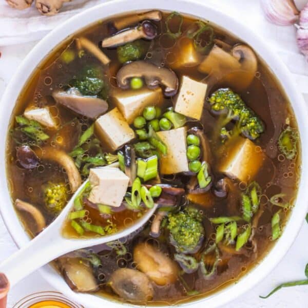 Easy one pot tofu soup with miso broth and fresh toppings on table.