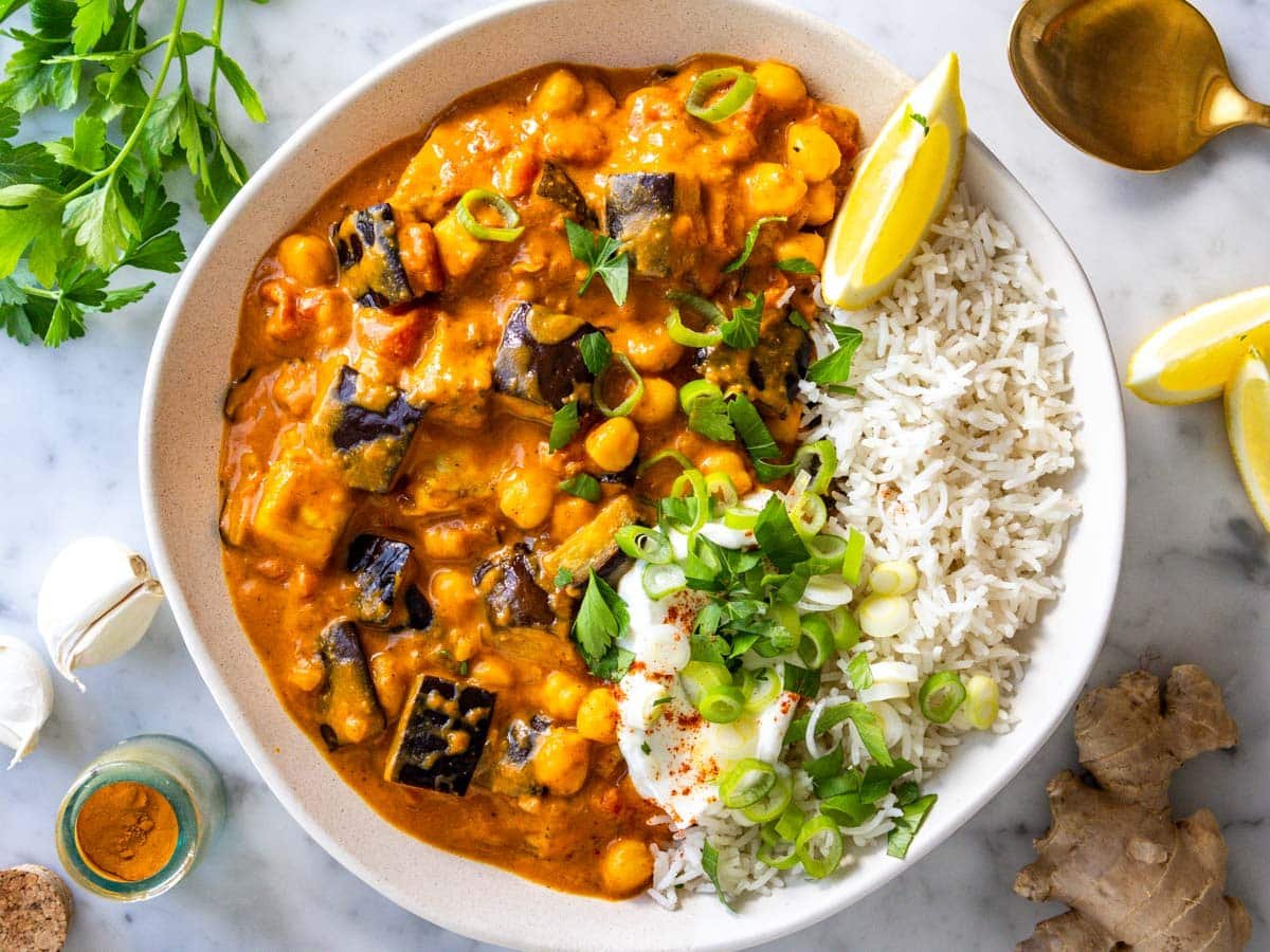 Eggplant curry served with basmati rice, yogurt, lemon juice, and cilantro.