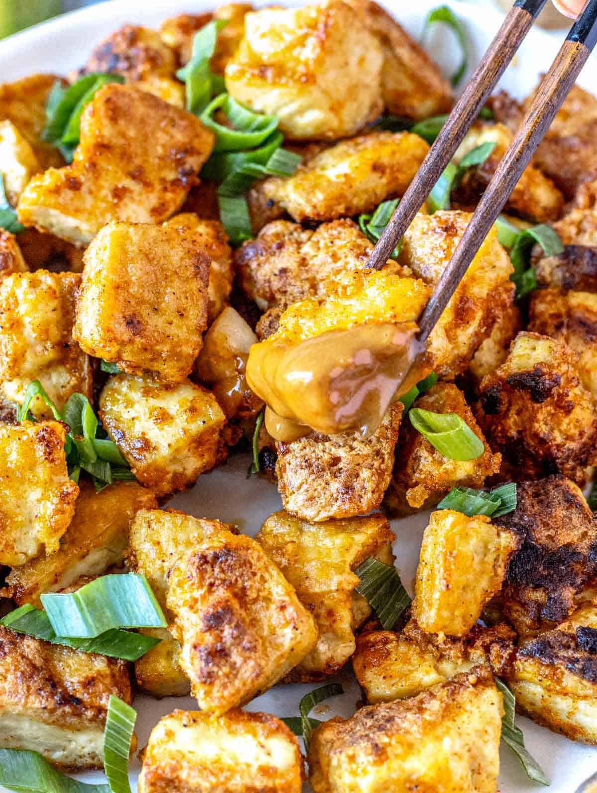 Fried tofu dipped in peanut sauce.