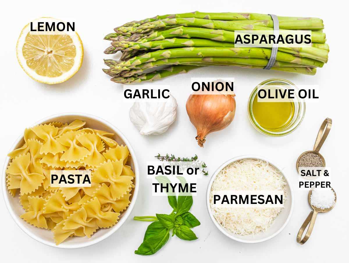 Ingredients for asparagus pasta on a table.