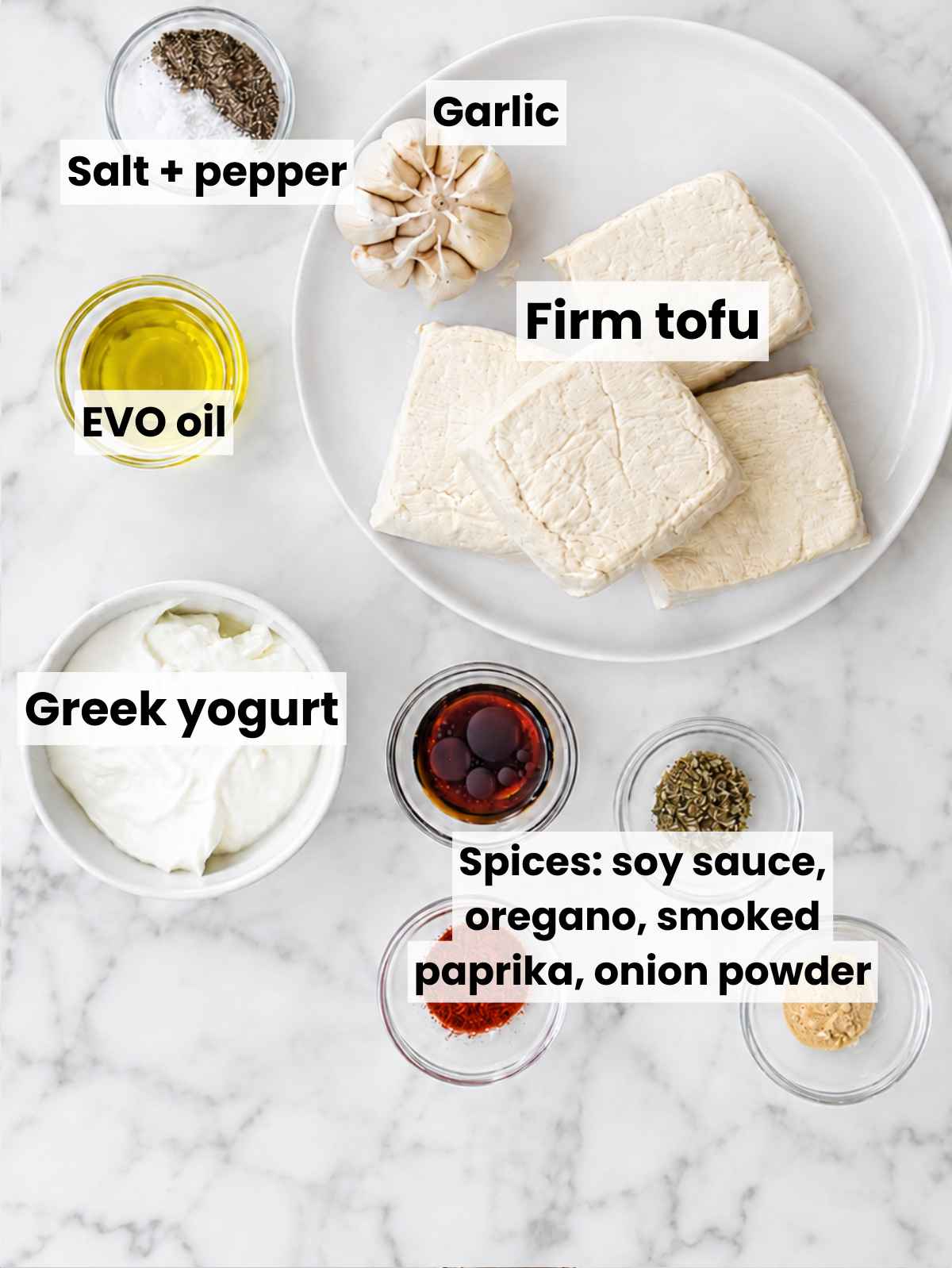 Ingredients for marinated tofu arranged on white Carrara marble in natural daylight.