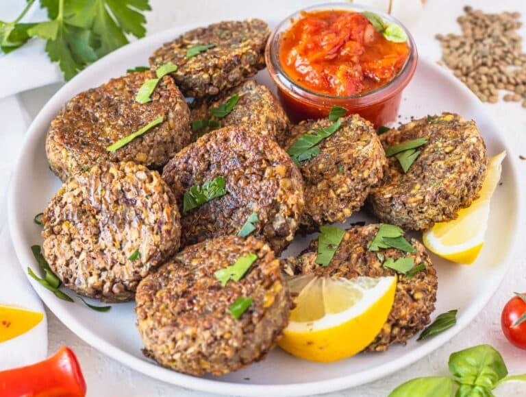 Lentil patties served with marinara sauce.