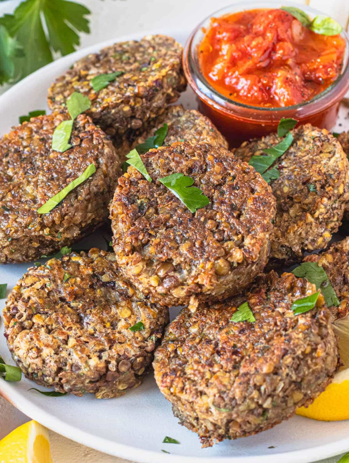 Lentil patties with marinara sauce and fresh parsley.