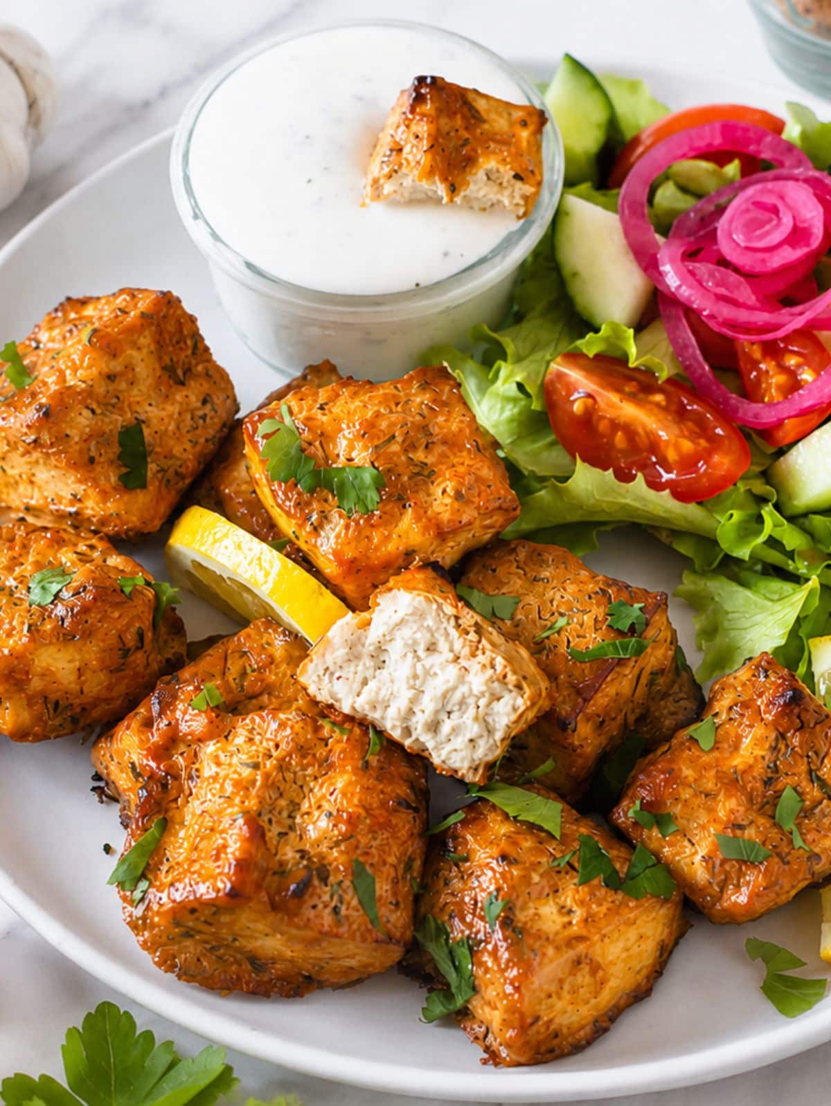 Marinated tofu and a green salad with ranch dressing.