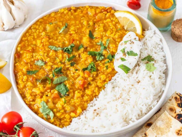 Moong dal served with basmati rice, yogurt, and fresh cilantro.